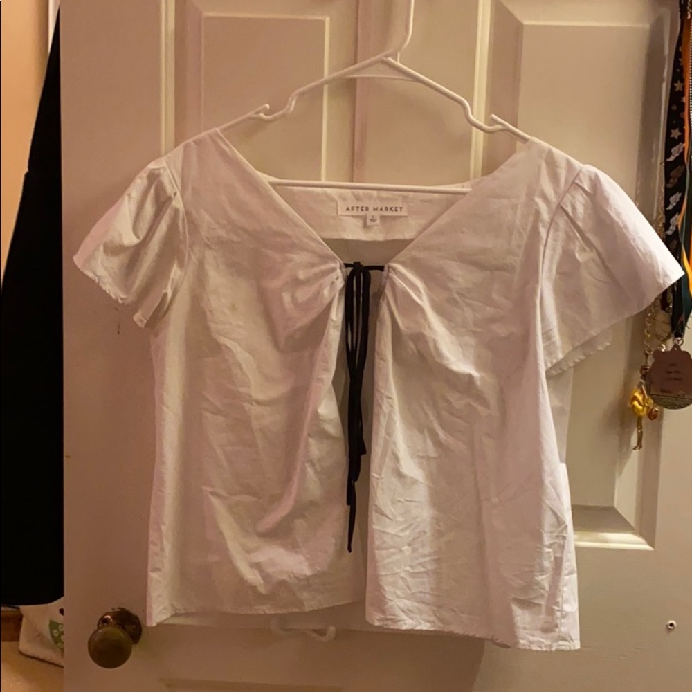 White blouse with a black tie